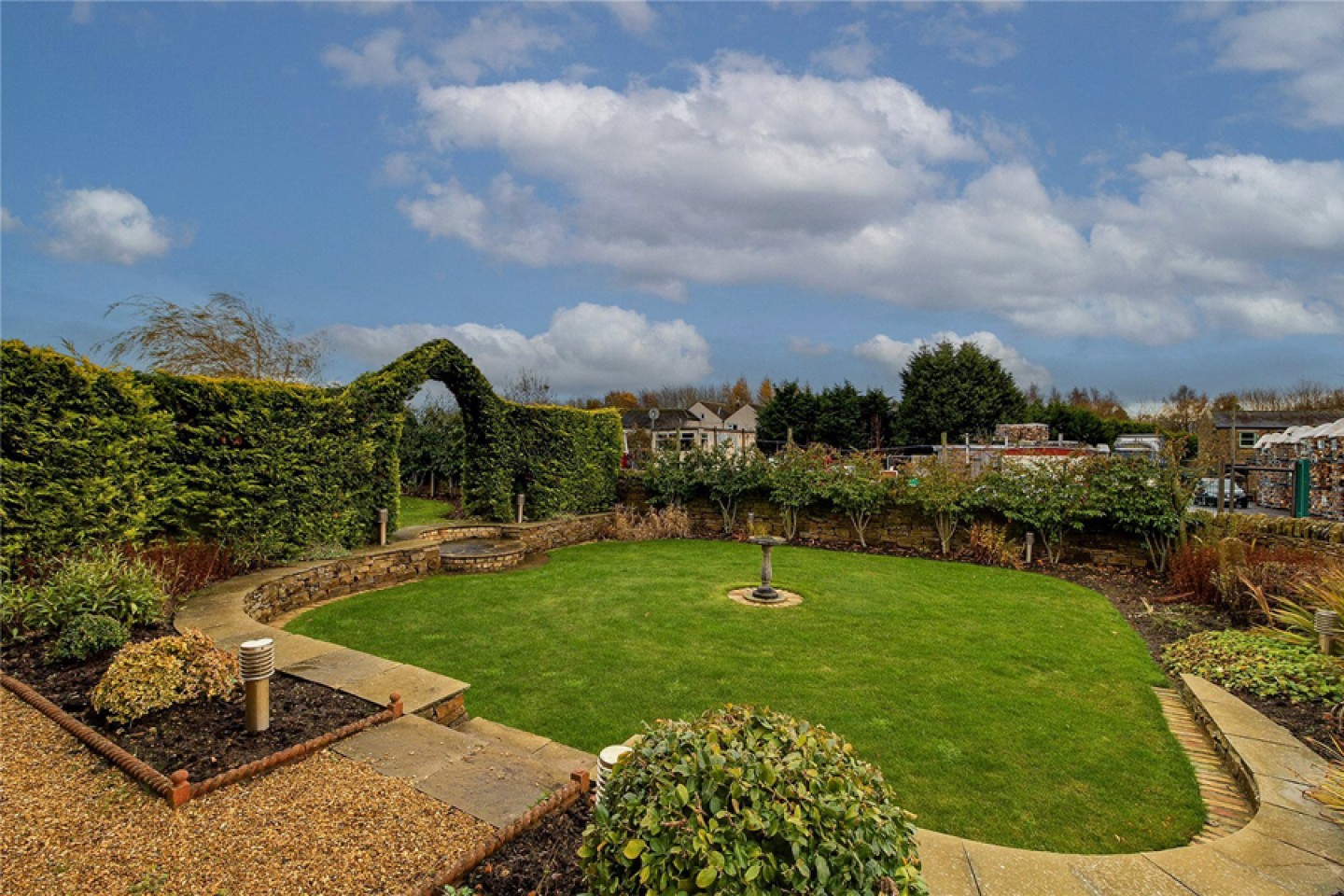 landscaped garden with green arch